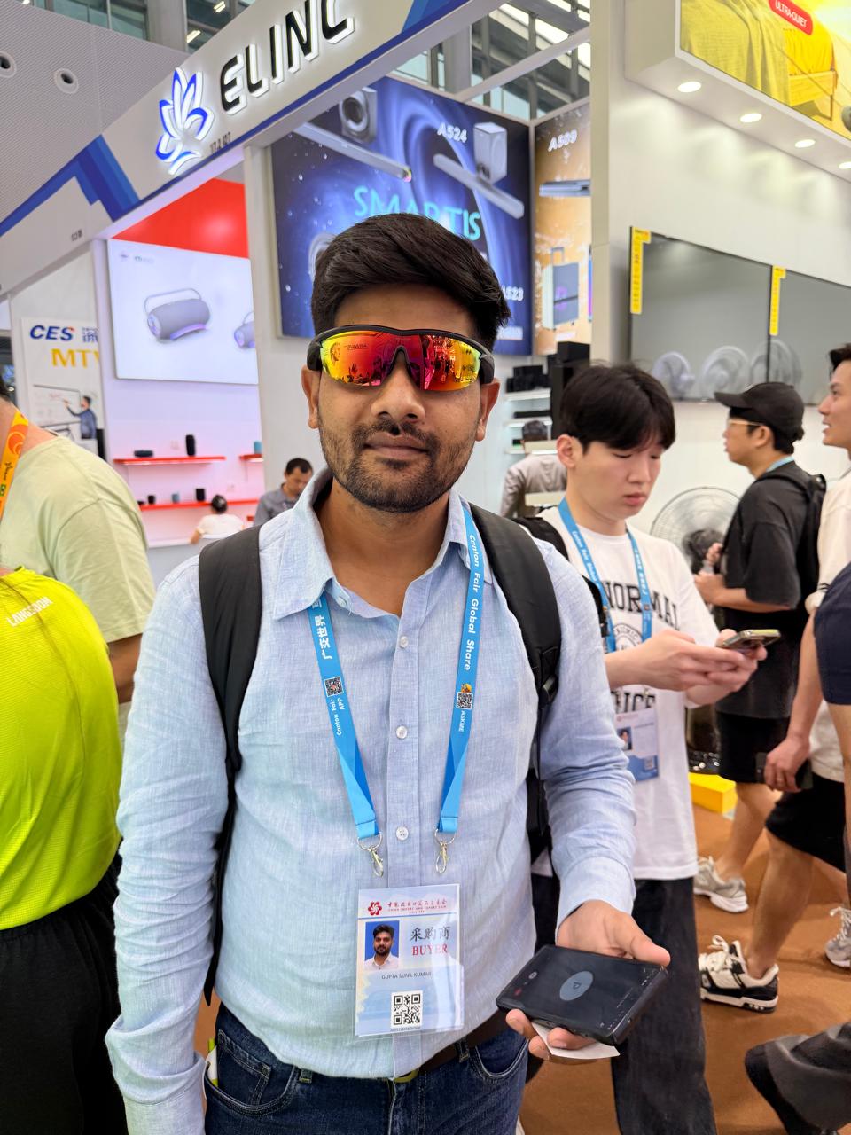 Delegate wearing an official Canton Fair buyer badge on the show floor